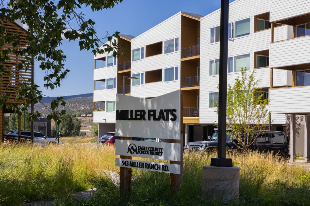 The Miller Flats sign with the building in the background